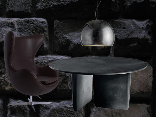 Tre pezzi must nell'arredo neo dark: tavolo, poltrona e lampada.